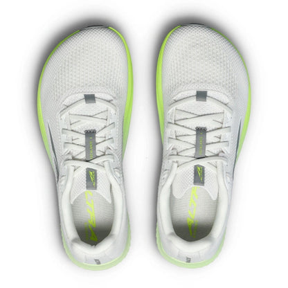 A pair of white altra running shoes with bright neon green accents on the midsole and tongue, shown from a top-down view on a white background.
